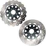Two TC Bros. 11.8" front floating brake rotors for 2006-2025 Harley-Davidson, one with a wavy edge and one with a round edge, both featuring circular cutouts and bolt holes, are displayed on a white background.