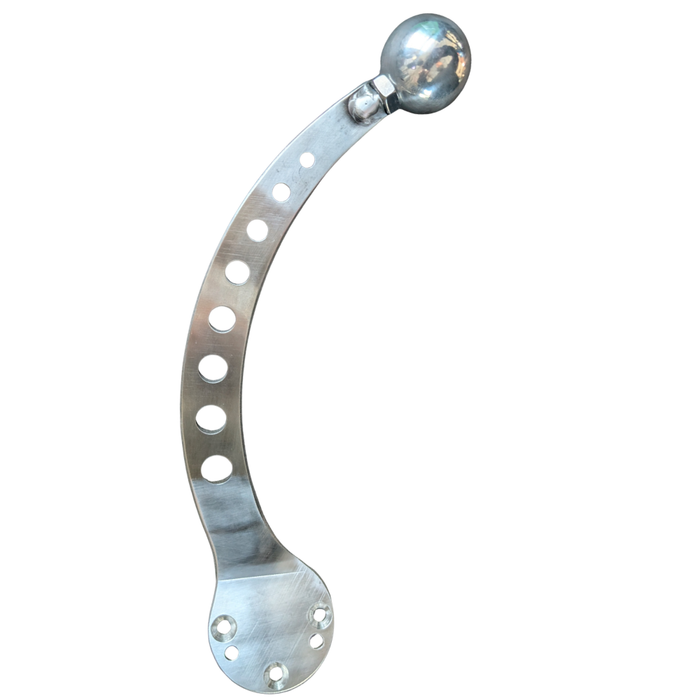 The Pangor Cycles Mini Shift Knob, a polished aluminum piece with a threaded hole, is shown next to a curved, perforated metal strip—both isolated on a white background.