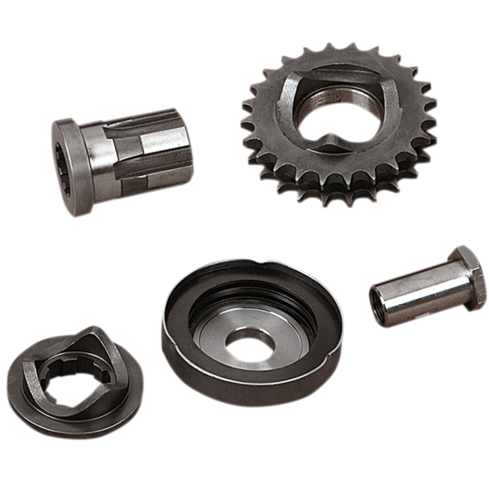 Five assorted metal mechanical parts, including gears and cylindrical components from the Drag Specialties Compensating Sprocket Kit for 1994-2006 Harley-Davidson Big Twin models, arranged separately on a white background.
