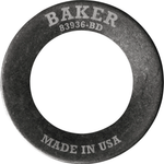 A Baker Drivetrain Comptimizer heavy duty metal washer, engraved with “BAKER” and “MADE IN USA,” is shown angled on a white background—designed specifically for use with 2011-up Harley Davidson Big Twin compensator spring assemblies.