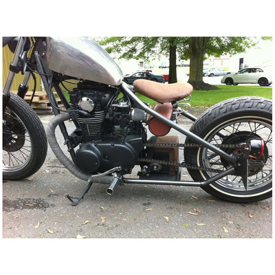A Monster Craftsman motorcycle parked in a parking lot, featuring a 1.25" Clamp On Chain Tensioner and a 530 Sprocket.