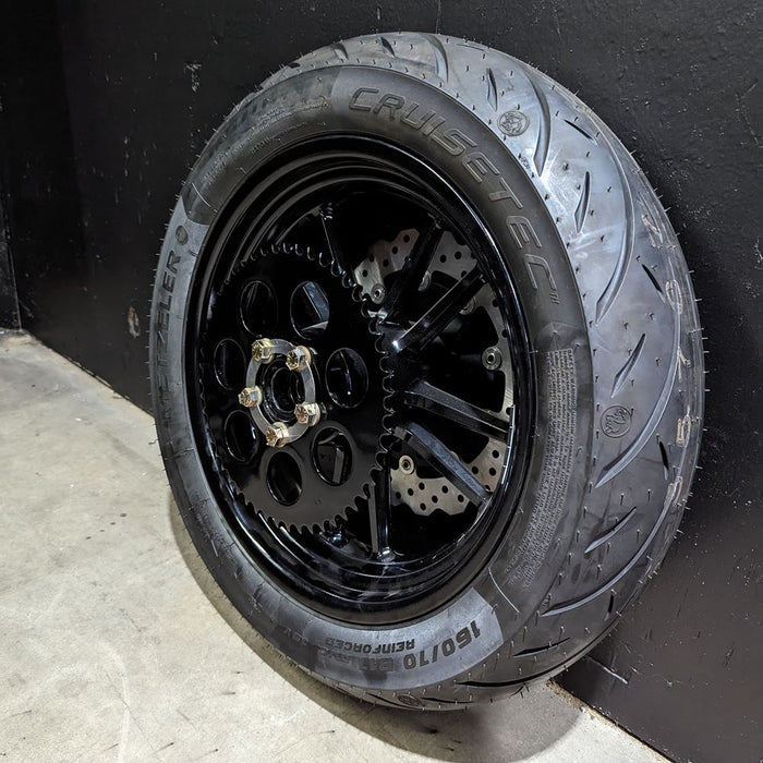 A black TC Bros. Sprocket Lock for Harley Davidson Rear Wheel Pulley Bolts on a black wall.