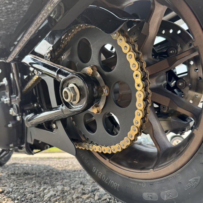 The TC Bros. Belt to Chain Drive Conversion Kit for 2018-Up Harley Davidson M8 Softail includes a large sprocket, small gear, hub, and hardware arranged on a white background—perfect for Milwaukee-Eight-powered models.