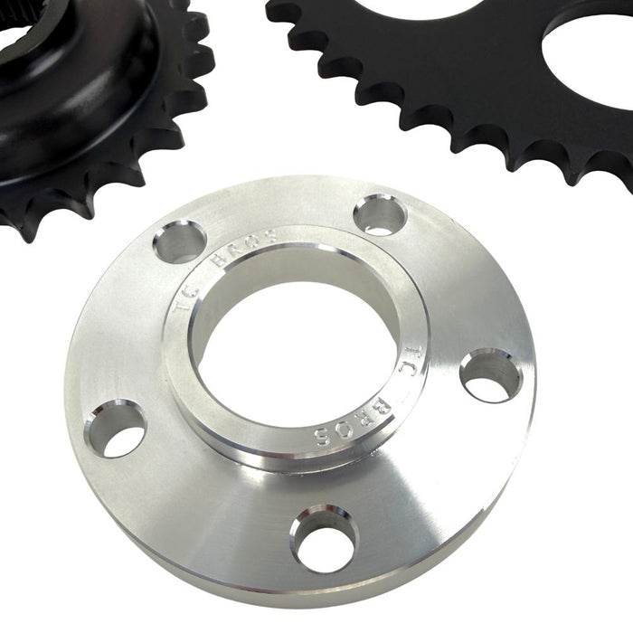 The TC Bros. Belt-to-Chain Drive Conversion Kit for 2000-2005 Harley-Davidson Dyna features 530 chain drive sprockets, bolts, washers, and mounting components displayed on a white background.