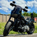 The TC Bros. Belt-to-Chain Drive Conversion Kit for 2018-Up Harley-Davidson Fat Bob includes two sprockets, gears, bolts, washers, and mounting hardware, all displayed on a white background.