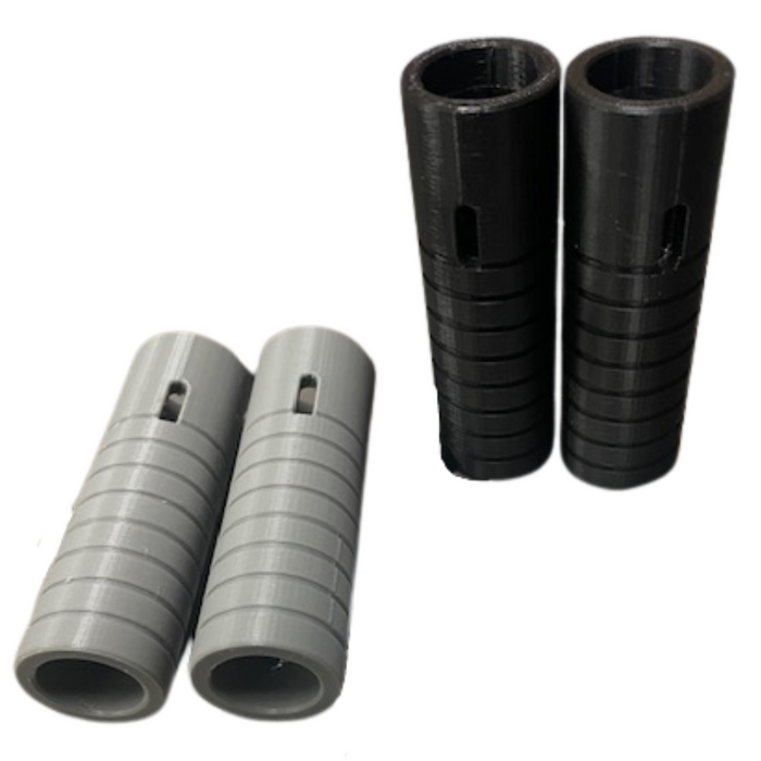 Two metal rods with grooves and yellow dots stand vertically, each flanked by a gray ridged sleeve—parts from the Hugh&