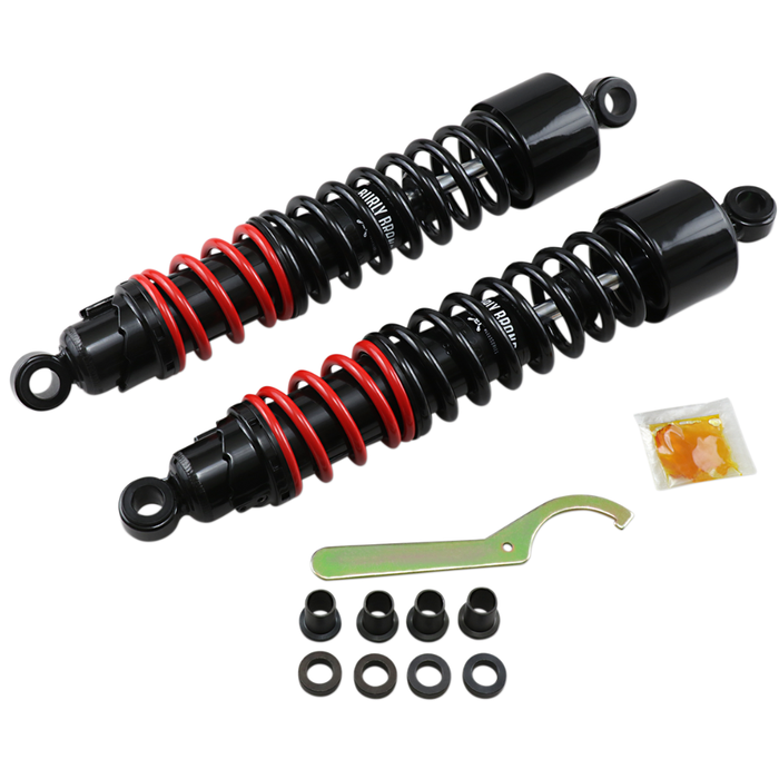 Burly Stiletto Shocks for 1986-2003 Harley-Davidson Sportster, including two black and red coil shocks, a metal spanner wrench, four bushings, four spacers, and a packet of lubricant.
