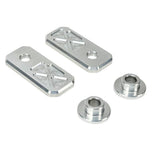 Two black and two silver rectangular plates with X-pattern engraving, plus two Handlebar Riser Bushings from the TC Bros. Handlebar Riser Bushing Conversion Kit, are arranged on a white background.