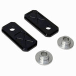 Two black and two silver rectangular plates with X-pattern engraving, plus two Handlebar Riser Bushings from the TC Bros. Handlebar Riser Bushing Conversion Kit, are arranged on a white background.
