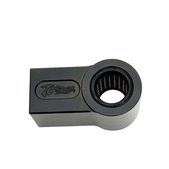 Two identical TC Bros. Shock Extensions for 2018-Up Harley-Davidson Softail, black metal with "TC Bros." engraving, shown side by side on a white background—perfect for upgrading your motorcycle suspension or lift kit.