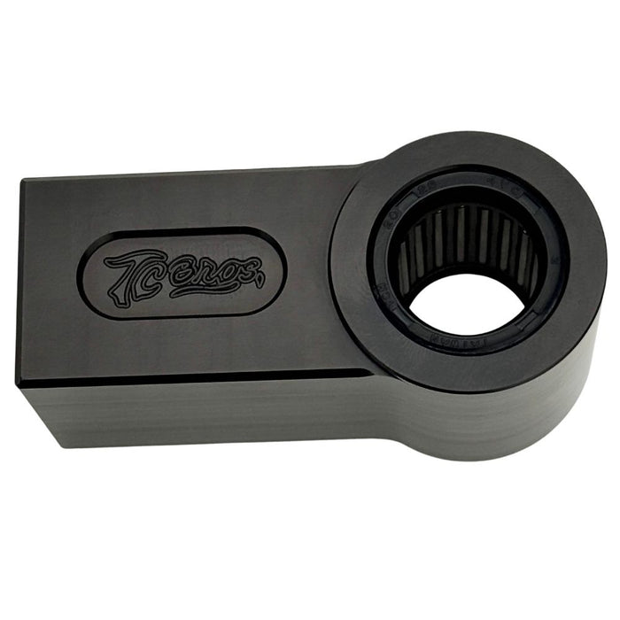 Two identical TC Bros. Shock Extensions for 2018-Up Harley-Davidson Softail, black metal with "TC Bros." engraving, shown side by side on a white background—perfect for upgrading your motorcycle suspension or lift kit.