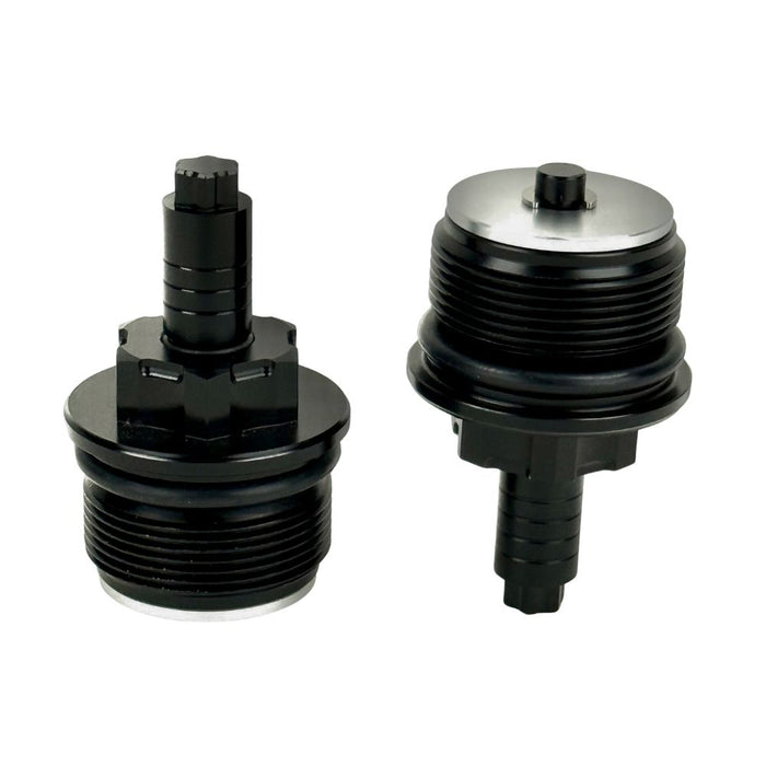 Two black metal Moto Iron Preload Adjusters for Harley-Davidson 39mm forks, featuring hexagonal tops and threaded bases.