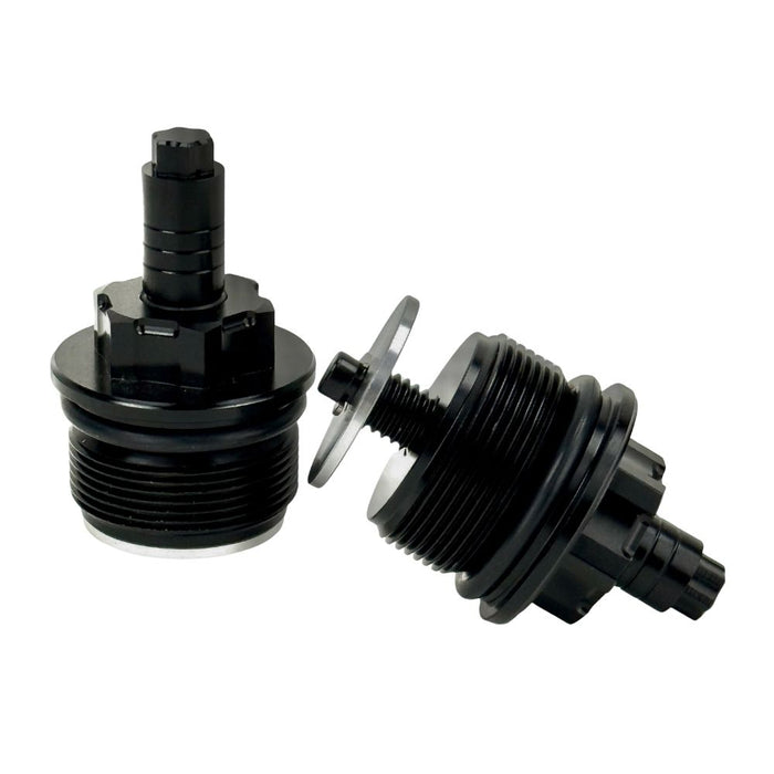 Two black metal Moto Iron Preload Adjusters for Harley-Davidson 39mm forks, featuring hexagonal tops and threaded bases.