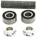 Two metal ball bearings, two shiny metal collars, and a cylindrical rod are arranged on a white background—components featured in the Wyatt Gatling Sealed Hub Bearing Conversion Kit for 1984-1999 Harley-Davidson wheels.
