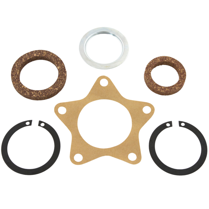 A set of seven OEM-replica gaskets and seals—including cork rings, a metal ring, a paper gasket, and two black snap rings—are arranged on a white background in the Wyatt Gatling Star Hub Gasket Kit by Wyatt Gatling, making it an ideal choice for restoring or maintaining your Harley-Davidson Servicar.