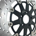 A TC Bros. 12.6in Oversized Front Floating Brake rotor for Harley Models, showcasing its corrosion resistance, placed against a white background.