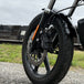 The TC Bros. Profile™ Front Floating Brake Rotor, compatible with 2023+ Harley Touring Bagger and 2021+ Pan America models, features a perforated round design crafted from high-carbon stainless steel with a black center and silver edge.