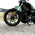 The TC Bros. Profile™ Front Floating Brake Rotor, compatible with 2023+ Harley Touring Bagger and 2021+ Pan America models, features a perforated round design crafted from high-carbon stainless steel with a black center and silver edge.