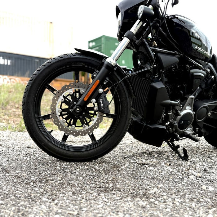 The TC Bros. Profile™ Front Floating Brake Rotor, compatible with 2023+ Harley Touring Bagger and 2021+ Pan America models, features a perforated round design crafted from high-carbon stainless steel with a black center and silver edge.