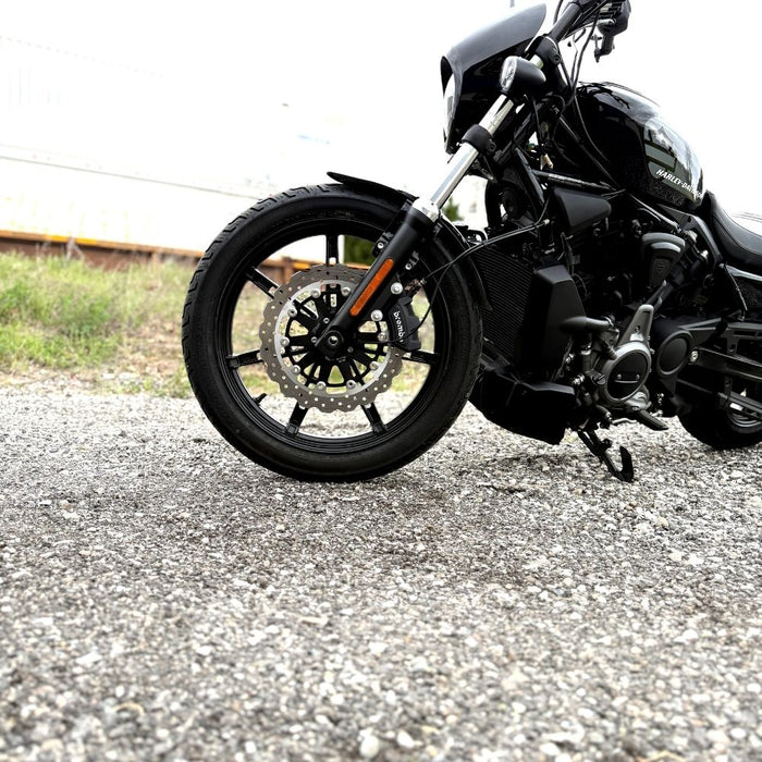 The TC Bros. Profile™ Front Floating Brake Rotor, compatible with 2023+ Harley Touring Bagger and 2021+ Pan America models, features a perforated round design crafted from high-carbon stainless steel with a black center and silver edge.