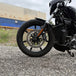 The TC Bros. Profile™ Front Floating Brake Rotor, compatible with 2023+ Harley Touring Bagger and 2021+ Pan America models, features a perforated round design crafted from high-carbon stainless steel with a black center and silver edge.