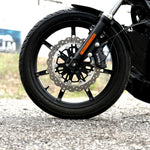 The TC Bros. Profile™ Front Floating Brake Rotor, compatible with 2023+ Harley Touring Bagger and 2021+ Pan America models, features a perforated round design crafted from high-carbon stainless steel with a black center and silver edge.