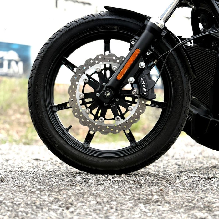 The TC Bros. Profile™ Front Floating Brake Rotor, compatible with 2023+ Harley Touring Bagger and 2021+ Pan America models, features a perforated round design crafted from high-carbon stainless steel with a black center and silver edge.