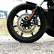 The TC Bros. Profile™ Front Floating Brake Rotor, compatible with 2023+ Harley Touring Bagger and 2021+ Pan America models, features a perforated round design crafted from high-carbon stainless steel with a black center and silver edge.