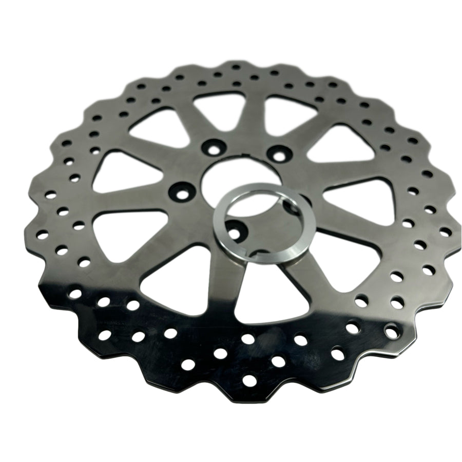 A TC Bros. 11.5in Profile™ Solid Mount Front Brake Rotor for 84-13 Harley Models Polished, a circular metal object with holes, commonly used as a front brake rotor for Harley models.