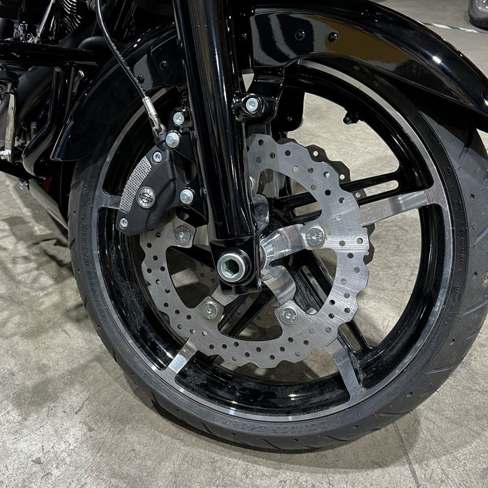 The TC Bros. Profile™ Front Floating Brake Rotor for 2024-up Harley Touring Bagger and 2021-up Pan America, crafted from stainless steel with edge holes and an irregular circular shape, mirrors the robust design of Harley Pan America&