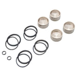 A set of metal cups, black rubber O-rings in various sizes, and two small black neoprene seals arranged on a white background. Ideal for use in a Drag Specialties Front/Rear Caliper Rebuild Kit - For 00-05 Sportster, 00-07 Big Twin, & 00-07 Dyna Models.