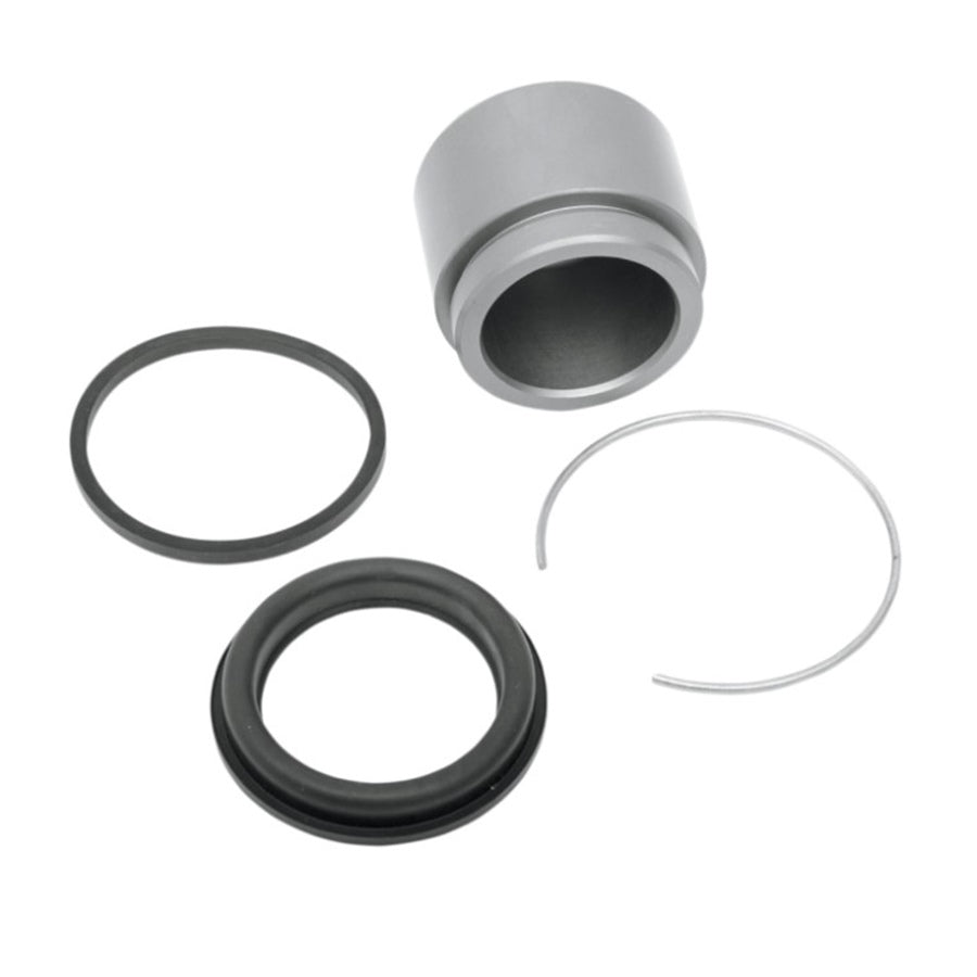 A disassembled mechanical seal with its various components laid out, including a seal face, an elastomeric o-ring of OEM# 4494686, and a spring for Rear Caliper Rebuild Kit for Big Twin, Dyna, Sportster models by Drag Specialties.