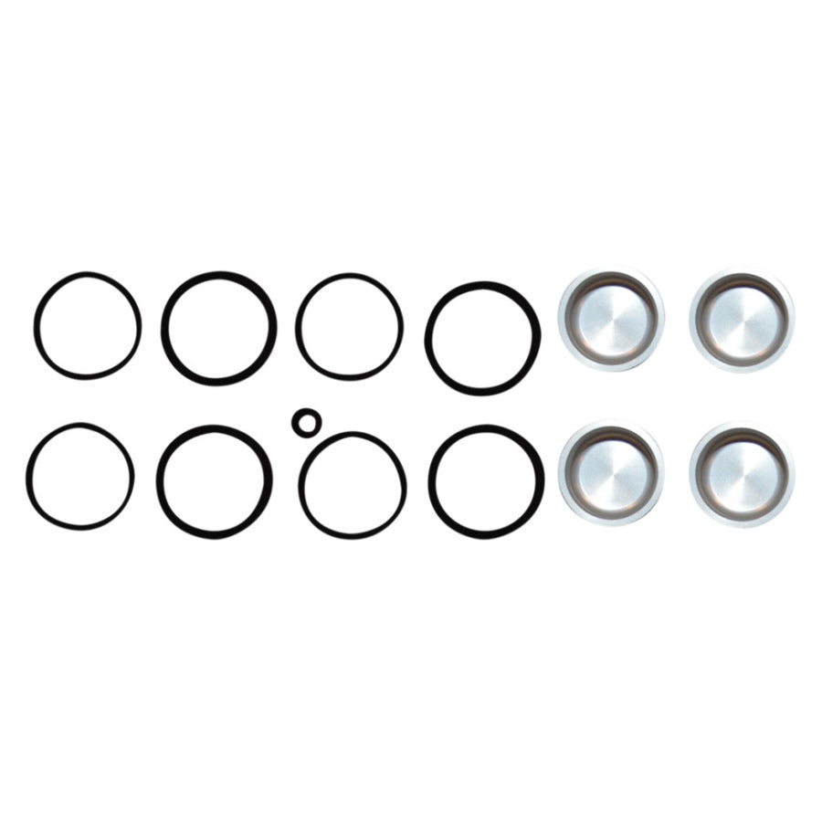 Ten black circles of varying sizes, a small black dot, and three metallic button-like objects arranged in two parallel rows reminiscent of Cycle Craft's Caliper Seal Kit and Pistons for V-rod, Sportster, and Big Twin models.