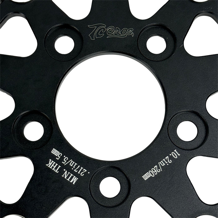 A close-up of the TC Bros. 10.25in Profile™ Rear Floating Brake Rotor, featuring a ventilated, perforated design with a black hub and silver ring—ideal for upgrading 2008-2022 Harley-Davidson Sportster brakes.