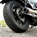 A close-up of the TC Bros. 10.25" Floating Rear Rotor, featuring a perforated metal disc with a black hub and silver ring, designed for 2022-Up Harley-Davidson Nightster rear brakes.