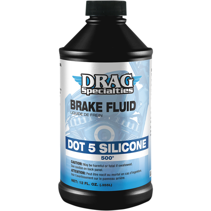 A 12 fl. oz. bottle of Drag Specialties DOT 5 Brake Fluid by Drag Specialties, featuring a blue and black label with product details and caution warnings.