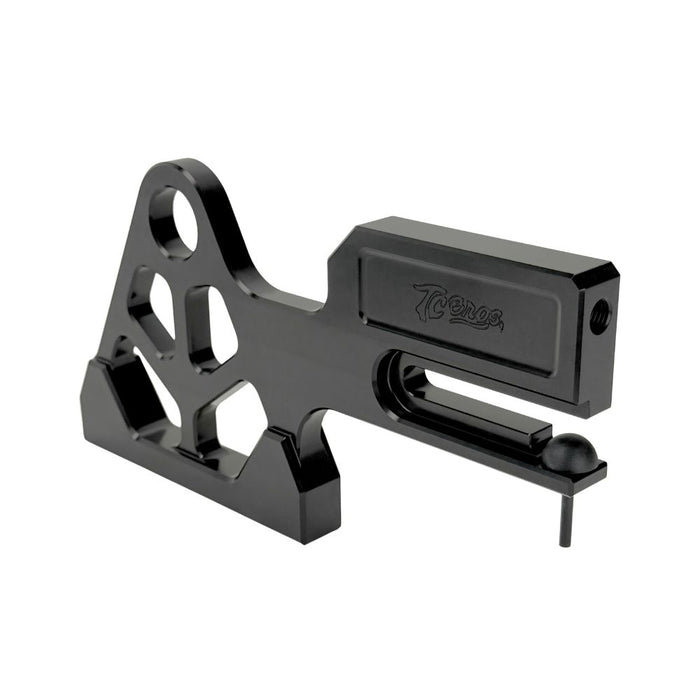 TC Bros. Pro Series Rear Radial Brake Bracket for 2018-Up Harley-Davidson M8 Softail, by TC Bros. Shown in black metal with multiple mounting holes, the kit includes a small attached hose, two bolts, a screw, washers, and copper rings—all arranged below on a white background—ideal for radial caliper conversion.