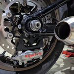 TC Bros. Pro Series Rear Radial Brake Bracket for 2018-Up Harley-Davidson M8 Softail, by TC Bros. Shown in black metal with multiple mounting holes, the kit includes a small attached hose, two bolts, a screw, washers, and copper rings—all arranged below on a white background—ideal for radial caliper conversion.