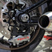 TC Bros. Pro Series Rear Radial Brake Bracket for 2018-Up Harley-Davidson M8 Softail, by TC Bros. Shown in black metal with multiple mounting holes, the kit includes a small attached hose, two bolts, a screw, washers, and copper rings—all arranged below on a white background—ideal for radial caliper conversion.