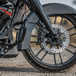 Four Arlen Ness Ness-Tech Differential Bore Front Calipers for 2008-Up Harley-Davidson, two in black and two in chrome, shown from different angles.