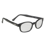 A pair of black-framed eyeglasses with clear lenses, labeled "KD XL Sunglasses - Clear" on the inside of the arm. Perfect for night riding or everyday use, these KD&
