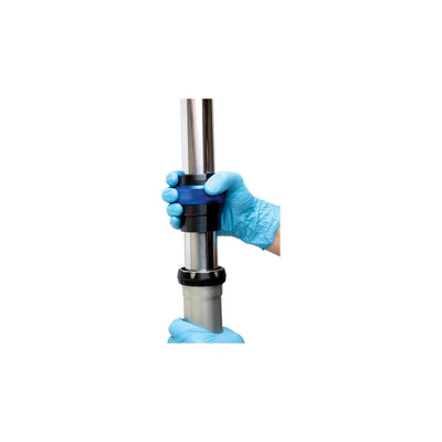 A person with blue gloves uses a Motion Pro 49mm Ringer Fork Seal Driver for a no-slip grip while holding a pipe.