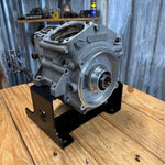 Black metal TC Bros. Engine Stand for 1999-2017 Harley-Davidson Twin Cam A motors, Touring, and Dyna; features "TC BROS" cutout and multiple mounting holes for secure installation.