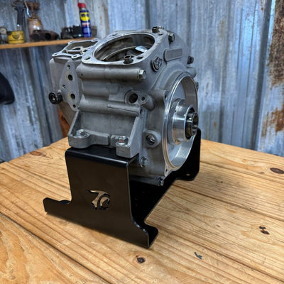 TC Bros. Engine Stand for 1999-2017 Harley Twin Cam A Motor (Touring & Dyna); black metal bracket with "TC BROS" cutout and multiple bolt holes—sturdy support for your engine.
