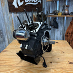 The TC Bros. Engine Stand for 2017-up Harley Milwaukee Eight Motor Bagger and M8 Softail features a black metal bracket with "TC BROS" cutout, upright tabs, and base mounting holes—perfect for securely holding your engine.