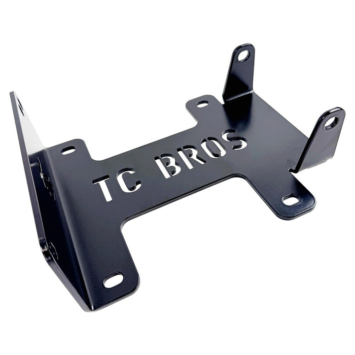 TC Bros. Engine Stand for 2000-2017 Harley-Davidson Twin Cam B Motor For Softail is a durable black metal bracket with multiple holes and "TC BROS" cutout, ideal for convenient engine maintenance. Photographed on a white background.