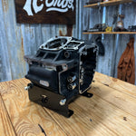 TC Bros. Engine Stand for 2000-2017 Harley-Davidson Twin Cam B Motor For Softail is a durable black metal bracket with multiple holes and "TC BROS" cutout, ideal for convenient engine maintenance. Photographed on a white background.