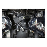 A close up of the S&S Cycle Premium 55mm CNC Ported Black Manifold for M8 Models engine of an M8 model motorcycle.