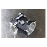 An image of a Premium 55mm CNC Ported Black Manifold for M8 Models by S&S Cycle on a metal surface with performance.