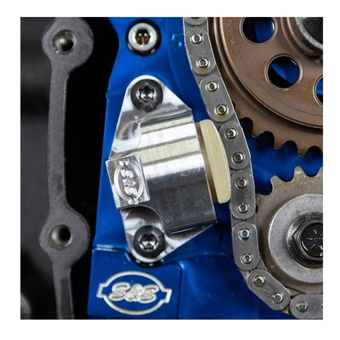 A blue gearbox with a chain, gears, and S&S Cycle Hydraulic Cam Chain Tensioner Kit for 2007-&